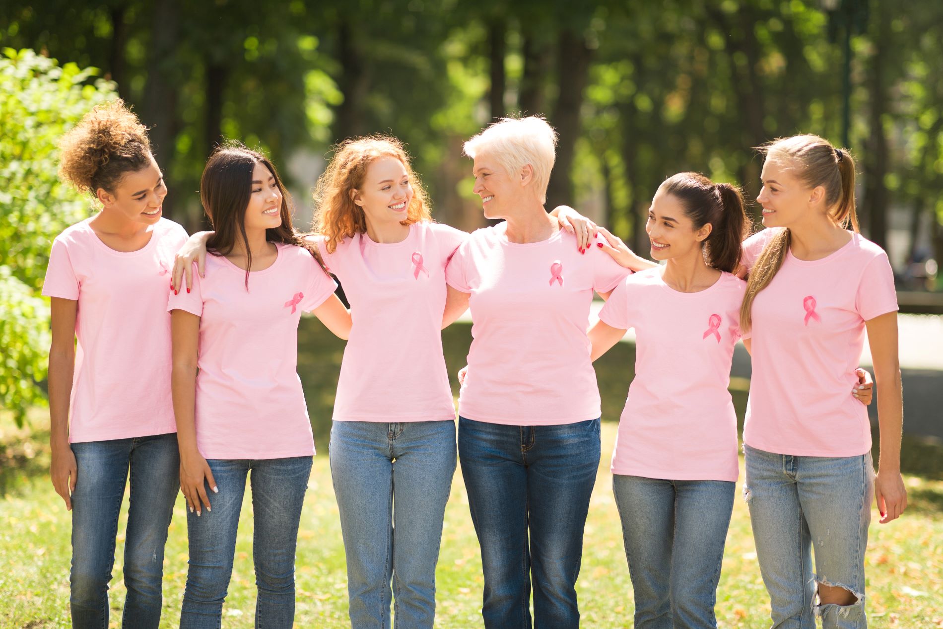 multiethnic-women-in-pink-ribbon-t-shirts-hugging--B5PZHFN